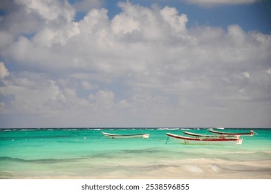 Fishing boats on turquoise waters of Tulum with cloudy skies - Powered by Shutterstock