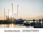 Fishing boats and pleasure crafts docked at a marina in Hilton Head Island, South Carolina, during a warm sunset