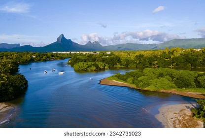fishing boats resting at tamarin bay, Mauritius island, indian ocean, Africa with Tamarin mountain on the background at sunset