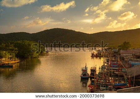 Fishing boats with sunset sky in fishing village, Ban Pak Nam Khaem Nu, Chanthaburi, Thailand.