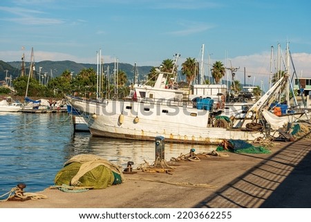 Fishing boats used for trawling (trawler), quayside with nets, ropes and moorage bollards. Port of La Spezia town, Gulf of La Spezia, Mediterranean sea, Liguria, Italy, Europe.