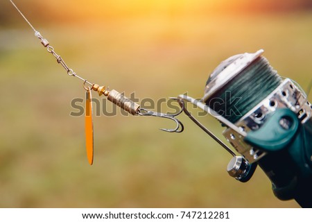 Fishing. Close-up of a fisherman holding a hook and baits, a bait for catching fish