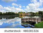 Fishing dock and blue sky is reflected in this landscape image of Stoughton, Wisconsin and the Yahara River.