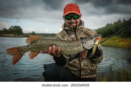 Fishing. Fisherman And Trophy Pike.