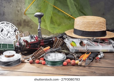 Fishing items on a table in a composition, wooden background.