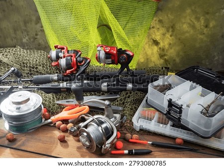 Fishing items on a table in a composition, wooden background.
