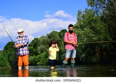 Fishing. Little Boy Fly Fishing On A Lake With His Father And Grandfather. Grandfather And Father With Cute Child Boy Are Fishing. Fly Fishing. Hobby And Sport Activity. Male Multi Generation Family