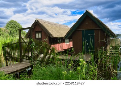 Fishing lodge on the lake near Krakow on the lake. Inland fishing. Vine roof on the house. Vacation resort in Germany. Landscape photo from nature - Shutterstock ID 2259118427