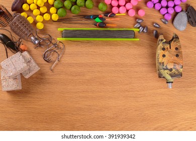 Fishing lure on a wooden table. Fishing tackle, baits, floats, feeders.