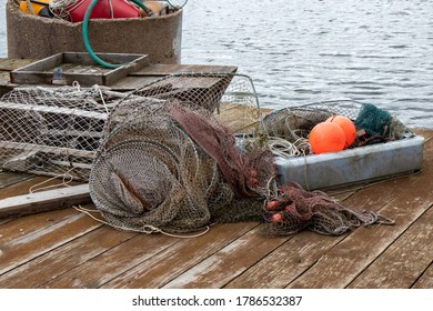 Fishing Net And Equipment Lying On A Wooden Bridge In The Dock