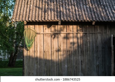 Fishing Net Hanging On Old Wall. Old Wood Shed.