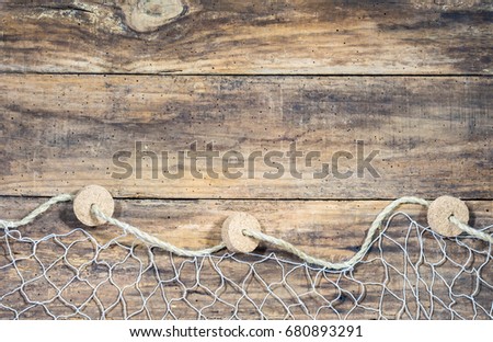 Fishing net on old wood, maritime nautical background texture.