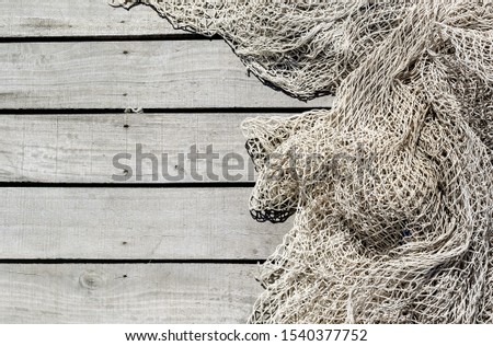 Fishing net on wooden decking of the pier background with copy space