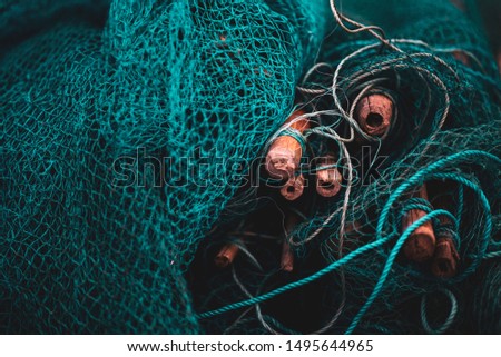 A fishing net is a net used for fishing. Nets are devices made from fibers woven in a grid-like structure. Some fishing nets are also called fish traps, for example fyke nets. Foto stock © 