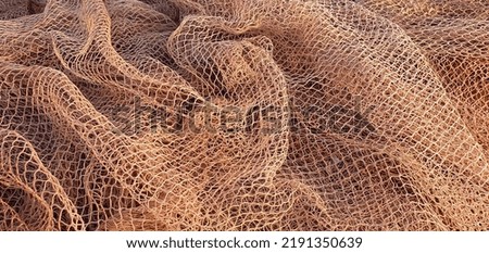Fishing nets for catching fish in the sea and ocean. Fishing nets on a ship. Texture of fishing nets.