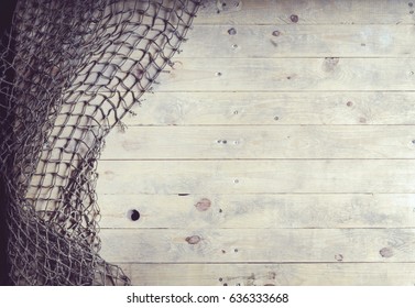 Fishing nets still-life on the wooden background.  