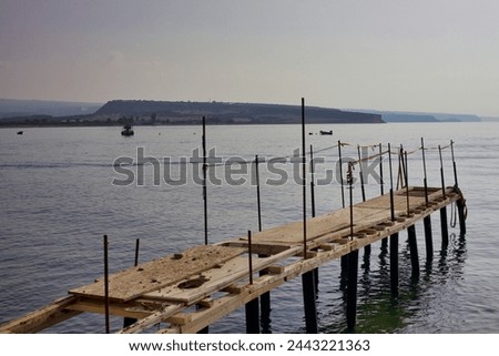 Fishing pier on the coast of Cyprus at Mandria, the wooden pier is for the local fisherman 