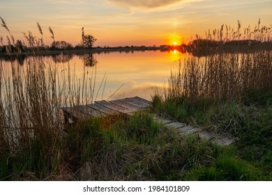 Fishing pier on the shore of the lake and sunset, Stankow, Lubelskie, Poland - Shutterstock ID 1984101809