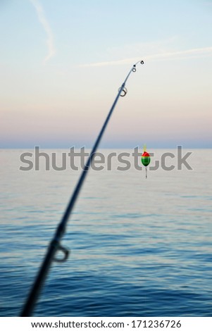 Fishing pole waiting to be cast, with line and sinker