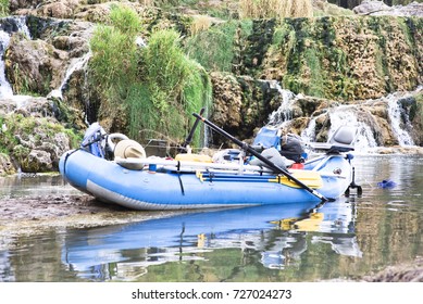 A Fishing Raft Sits In Front Of Waterfalls On The Snake River In Idaho. 