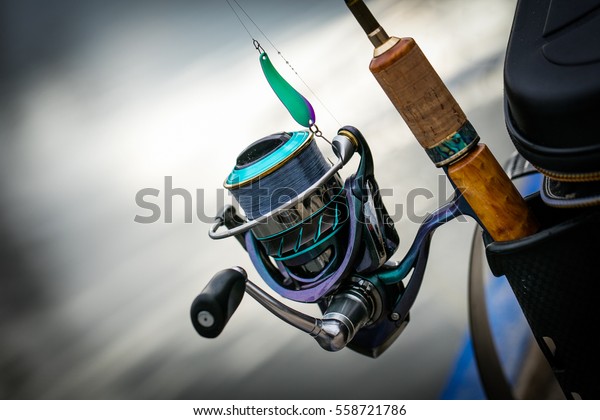 Fishing reel, blurred\
background.