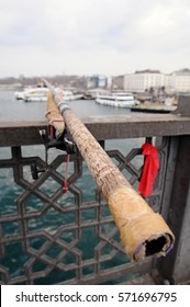 Fishing rod at Galata bridge with view to ships at sunset in Istanbul, Turkey