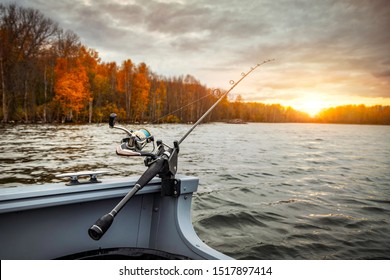 Fishing rod on the boat, sunset time. Beautiful autumn colors. A fishing rod is a long, flexible rod used by fishermen to catch fish.  - Powered by Shutterstock