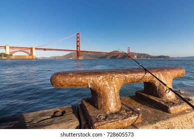 A Fishing Rod On An Iron Dock Cleat At The Golden Gate Bridge, San Francisco.