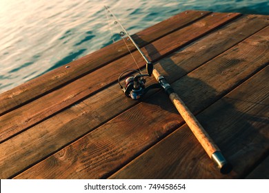 Fishing Rod On A Wooden Dock.