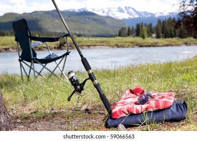 Fishing Rod And Pile Of Clothes Leaning Against A Tree By The Snake River