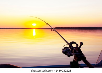 Fishing rod spinning with the line close-up. Fishing rod in rod holder in boat due the fishery day at the sunset. Rod rings. Fishing tackle. Fishing spinning reel. - Shutterstock ID 1469032223