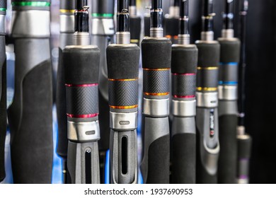 fishing rods of different construction and purpose on the counter of the store. Background of fishing rods