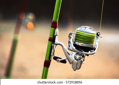 fishing rods with spinning and reel of a fisherman for surfcasting in beach shore