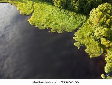 Fishing Rowboat Moored In The Tall Grass By The Shore. View From Above