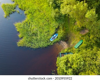 Fishing Rowboat Moored In The Tall Grass By The Shore. View From Above
