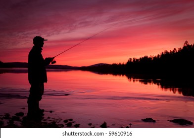 Fishing spinning at sunset. Silhouette of a fisherman