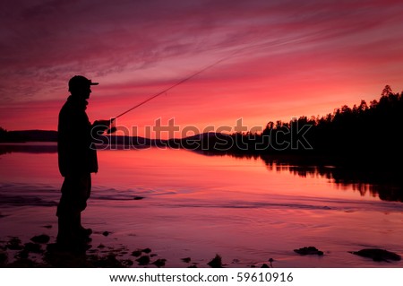 Fishing spinning at sunset. Silhouette of a fisherman