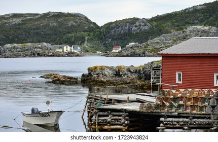 Fishing stage, lobster pots with boat moored to the wharf, in the harbour of Salvage, Newfoundland and Labrador Canada - Shutterstock ID 1723943824