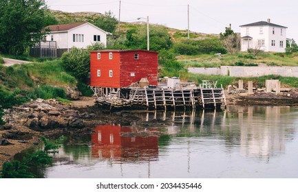 Fishing stage with traditional red and white saltbox houses in Salvage, Newfoundland, Canada on a summer day. - Shutterstock ID 2034435446