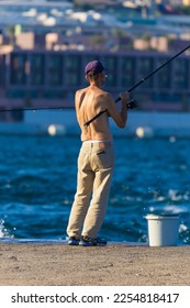Fishing tackle, fishermen and fishing rods in the sea. - Shutterstock ID 2254818417