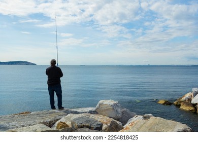 Fishing tackle, fishermen and fishing rods in the sea. - Shutterstock ID 2254818425