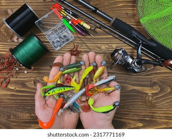 Fishing tackle. Float, wobbler, bait hooks, on a wooden background. Selective focus - Shutterstock ID 2317771169