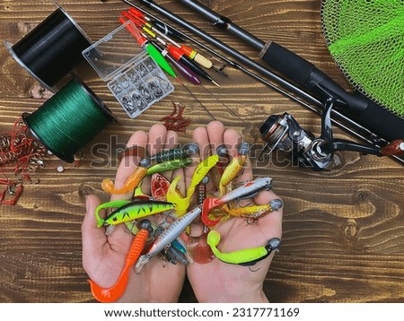 Fishing tackle. Float, wobbler, bait hooks, on a wooden background. Selective focus