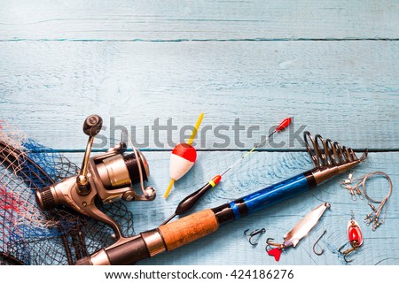 Fishing tackle on wooden blue background