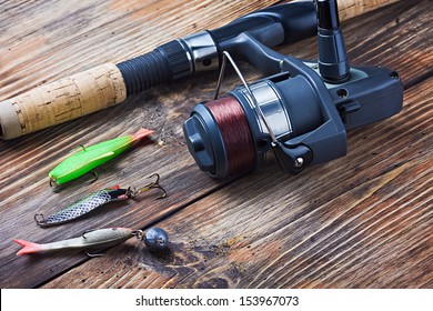 fishing tackle on a wooden table 
