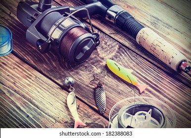 fishing tackle on a wooden table. toned image - Powered by Shutterstock