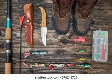 Fishing Tackles And Fishing Gear On Wooden Background, Top View