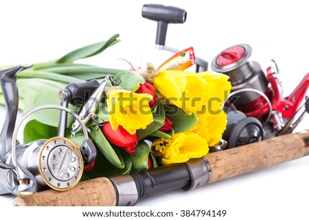 fishing tackles with spring flowers narcissus and tulips on white background for outdoor active business for women present