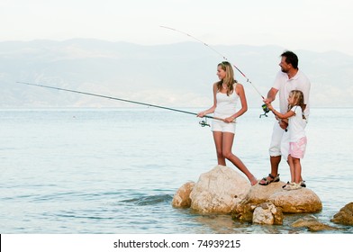 Fishing team - family fishing at the beach - Powered by Shutterstock