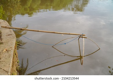 a fishing trap is placed in a quiet pond